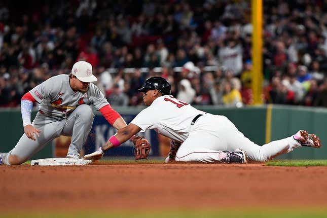 May 14, 2023; Boston, MA, USA; Boston Red Sox third baseman Rafael Devers (11) is caught by St. Louis Cardinals second baseman Nolan Devers in the fourth inning at Fenway Park Gorman (16) was out at second base.